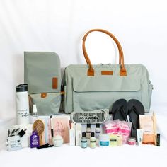 an assortment of personal care items displayed in front of a gray bag on a white background