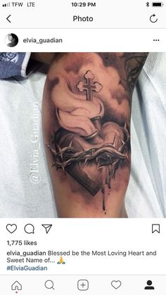 a tattoo on someone's arm with a cross and crown in the middle of it