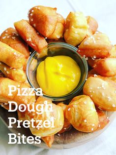 a bowl filled with dough and pretzel bites next to a jar of mustard