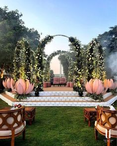 an outdoor ceremony setup with flowers and greenery