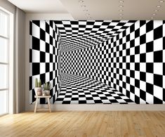 a black and white checkered wall in an empty room with a potted plant