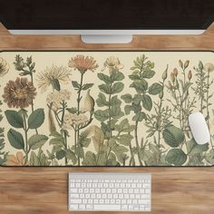 a computer keyboard sitting on top of a wooden desk next to a mouse and monitor