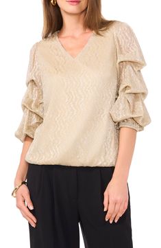 Simmered in shimmer and set with elegant statement sleeve, this party-ready top will get glasses raised in tribute. 24" length V-neck Three-quarter sleeves 100% polyester Machine wash, tumble dry Imported Glamorous Formal V-neck Blouse, Gold V-neck Blouse For Work, Elegant V-neck Holiday Tops, Elegant V-neck Tops For Festive Occasions, V-neck Shimmer Tops For Party Season, Evening V-neck Top With Blouson Sleeves, Glamorous V-neck Blouse, Evening Tops With 3/4 Sleeves For Fall, Fall Evening Tops With 3/4 Sleeves