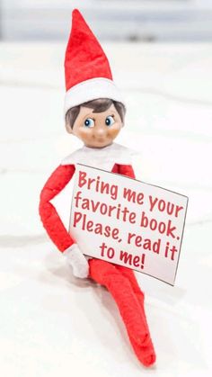 an elf holding a sign that says bring me your favorite book please, read it to me