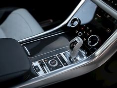 the interior of a modern car with black leather and chrome trims, including an automatic steering wheel