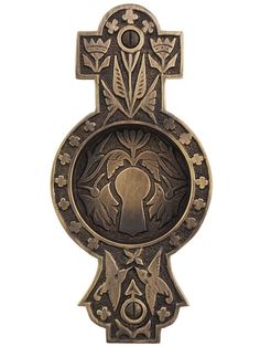 an ornate metal door handle with a keyhole and decorative designs on the front side