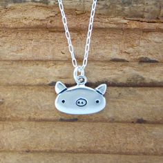 "This cute little pig necklace is made from sterling silver and measures about 1/2 of an inch tall and wide. Shipped as the charm only or on your choice of silver-plated or sterling silver cable chain in either 16\", 18\", or 20\". Please use the drop down menu for your options. To see the matching earrings go here: https://www.etsy.com/listing/551264706/pig-earrings-sterling-silver-pig?ga_search_query=pigs&ref=shop_items_search_8 To see all my little charms go here: https://www.etsy.com/sho Cute Nickel-free Sterling Silver Necklaces, Cute Sterling Silver Pendant Charm Necklaces, Cute Sterling Silver Pendant Charm Necklace, Cute Hypoallergenic Silver Charm Necklaces, Cute Sterling Silver Necklace For Everyday, Cute Nickel-free Silver Charm Necklace, Cute Silver Sterling Silver Charm Necklaces, Cute Silver Nickel-free Charm Necklaces, Cute Silver Nickel-free Charm Necklace