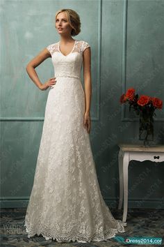 a woman in a wedding dress standing next to a table with flowers on it and an instagram page