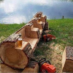 there is a log with beer glasses on it next to some logs that have been cut down