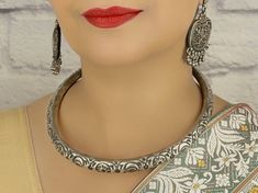 Beautifully handcrafted in Jaipur, this traditional tribal 925 sterling silver Hasli choker has an excellent finish which gives out an exquisite sense of style. What's Included: 1 925 Silver Hasli Choker Material: 92.5 Hallmarked Sterling Silver  Lock System: Twist/ Latch Finish: Oxidized Silver  Nickel Free/Lead free This is handcrafted item: Our 92.5 hallmarked sterling silver jewelry is handmade by skilled artisans in Rajasthan, India using traditional,  centuries old jewelry making techniques.  Packaging: * All jewelry pieces are sanitized and cleaned with jewelry cleaner before  packing. * All our jewelry pieces are delivered ready as gifts, packaged in a cotton filled paper box and a bow tie ribbon. Silver Care:  * Keep in cool dry place in plastic bag provided to avoid tarnishing. D Indian Bridal Necklace, Cuff Necklace, Handmade Choker Necklace, Sterling Silver Choker Necklace, Tie Ribbon, Sterling Silver Choker, Silver Choker Necklace, Pakistani Jewelry, Silver Choker