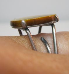 "Wonderful vintage mid century genuine Tiger's Eye sterling silver unisex ring. Ring size 8, but it slightly adjustable up and down. The stone measures 3/4\" x 1/2\" in the center front. Unmarked, but acid tested solid sterling silver. Total weight is 6.2 grams. In excellent gently used vintage condition. Please note, items in photos may appear larger than actual size. Be sure to read description for size and check all photos for comparison. 201207 ------------------------------------------ Your Adjustable Retro Ring, Retro Adjustable Ring, Handmade Adjustable Retro Rings, Vintage Brown Jewelry With Polished Finish, Vintage Adjustable Metal Rings, Retro Handmade Adjustable Ring, Vintage Adjustable Rings With Polished Finish, Vintage Brown Ring With Polished Finish, Nickel Free Vintage Open Ring