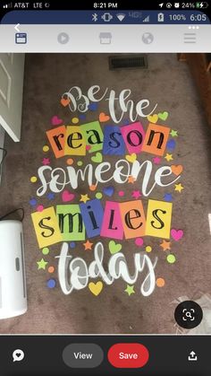 someone wrote this message on the floor in front of their computer screen to say, be the reason someone smiles today