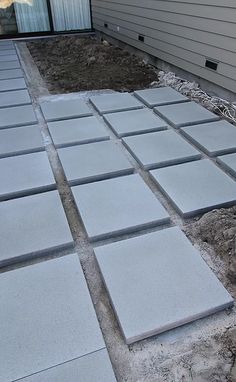 an outdoor patio being built with concrete blocks and cement pavers laid out on the ground