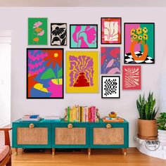 a living room filled with lots of art on the wall