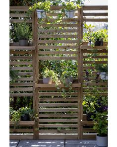 a wooden trellis with potted plants in it