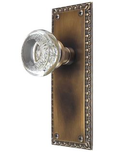 an antique style door handle with a glass knob