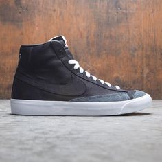 Nike Men Blazer Mid '77 Vintage We (black / black-black-white) Black High-top Skateboarding Sneakers With Rubber Waffle Outsoles, Black High-top Sneakers For Skateboarding With Rubber Waffle Outsoles, Black Leather Skate Shoes With Rubber Waffle Outsoles, Classic Leather High-top Sneakers For Skateboarding, Vintage Leather Skate Shoes With Contrast Sole, Black High-top Sneakers With Gum Sole For Skateboarding, Black Retro Skate Shoes With Contrast Sole, Classic Black High-top Sneakers With Contrast Sole, Vintage Leather Skate Shoes For Skateboarding