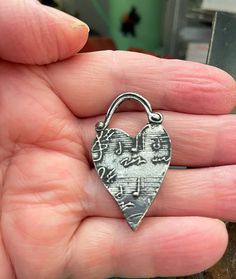 "This pendant charm is covered with musical notes. Perfect gift for a musically talented person. As with all my charms and pendants, this one is made of jewelry-grade pewter. It is designed, hand-casted and hand finished by me. Weight: 4 grams Size: 1 1/2\" tall, .87\" wide" Nickel Free Metal Heart Charms, Nickel-free Heart-shaped Metal Charms, Nickel-free Metal Heart Charms, Silver Heart-shaped Music-themed Jewelry, Music-themed Silver Heart Jewelry, Pendant Heart, Pewter Pendant, Musical Notes, Handmade Charms