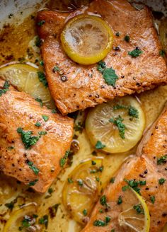 chicken with lemons and parsley on top in a baking dish, ready to be eaten