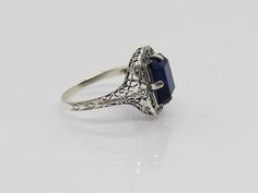 Vintage Sterling Silver Blue Sapphire Filigree Ring ....Marked 925...Total of weights 2.3grams...Size 8...Measure of Face 14.7MM...It's in very good condition. Victorian Blue Sapphire Ring Hallmarked, Intricate Blue Sapphire Ring, Elegant Blue Engraved Ring For Anniversary, Vintage Blue Ring With Diamond Cut, Vintage Blue Diamond Cut Jewelry, Blue Filigree Ring Hallmarked, Blue Hallmarked Filigree Ring, Formal Sapphire Ring Stamped 925, Vintage Blue Sapphire Ring With Intricate Design