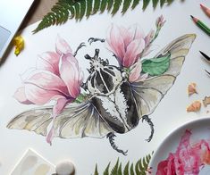 a drawing of a bug with flowers and leaves on the table next to some crayons