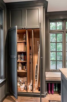 an open cabinet in the middle of a kitchen with lots of cupboard space and drawers