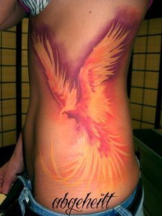 a woman's stomach with a bird tattoo on it