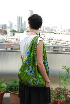 This soft, foldable, strong cotton tote bag is made from African wax print cotton known as kitenge. First developed by the Dutch who adapted the technique from Indonesian batik, wax print fabrics are now made in Holland as well as throughout Sub-Saharan Africa. No longer made using wax resist, these days they are industrially produced, colorful cotton cloths with batik printing. The bag design is based on a traditional Japanese bag which in turn must have been inspired by a furoshiki (Japanese w Japanese Furoshiki Wrapping, Batik Bag, Fabric Christmas Stocking, Japanese Wrapping Cloth, Japanese Wrapping, Vintage Kimono Fabric, Furoshiki Wrapping, Japanese Bag, Indonesian Batik