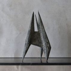 a metal sculpture sitting on top of a shelf