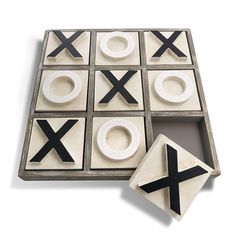 a tic - tac - toe game with white and black tiles