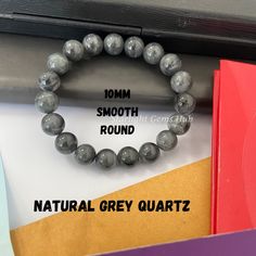 Product Description: Item Code: SGH-29 Stone Name: Grey Quartz Size: 10MM Shape: Smooth Round Color: Grey  Length: Stretchable Weight: 166Cts (Approx.) Lock: 925 Lobster Clasp **All natural gemstones vary in color and pattern. We try our best to make our photos represent the real products in person. ** **All Customization Facility Is Available as per your Requirement Also in Other stones. ** **Bulk Order also available** **Please feel free to contact for any further queries** Grey Quartz, Gray Gemstones, Gray Jewelry, Rose Quartz Bracelet, Unisex Bracelets, Quartz Bracelet, Jade Beads, All Natural, Natural Gemstones