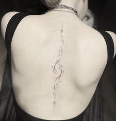 the back of a woman's neck with writing on it