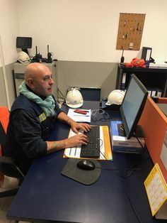 a man sitting at a desk using a computer