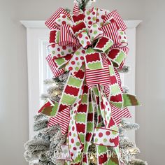 a christmas tree decorated with red, green and white bows