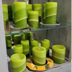 many green candles sitting on top of a table