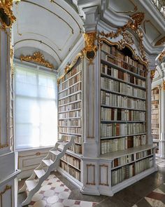 an elaborately decorated library with many bookshelves