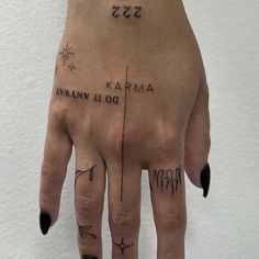 a person's hand with tattoos on it and writing on the fingers that spell out their names