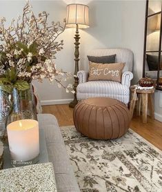 a living room filled with furniture and a vase full of flowers on top of a table