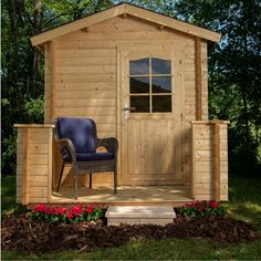 a small wooden cabin with a chair on the porch