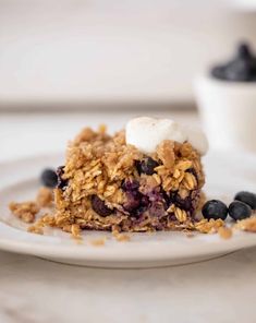 a close up of a plate of food with blueberries and granola on it