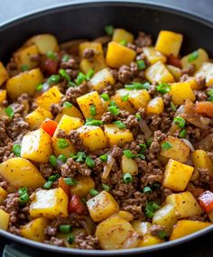 a skillet filled with ground beef and potatoes