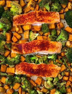 salmon and broccoli with sweet potatoes on a baking sheet in the oven, top view