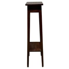 a tall wooden stool with one foot on the ground