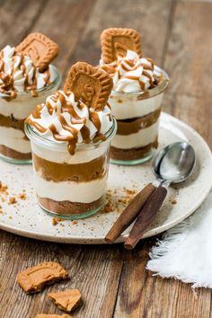 three desserts with cookies and whipped cream on a plate