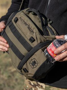 a person holding a backpack with a water bottle in it