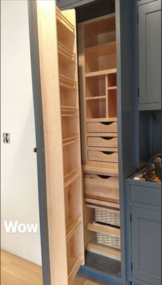 an open cabinet with drawers and baskets in it