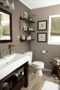 a bathroom with green walls and white fixtures