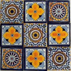 an artistic tile design with orange and blue flowers