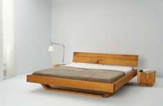 a bed that is made up and sitting on the floor