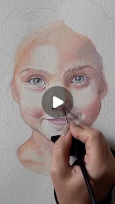 someone is drawing a face with colored pencils